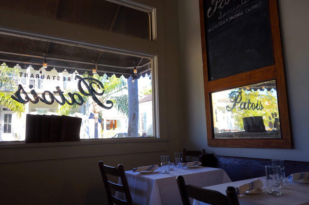 The Patois window decal is reflected in a mirror