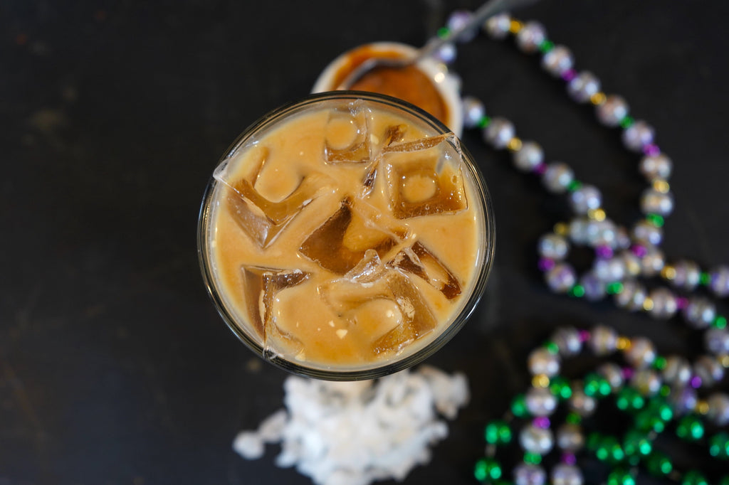 Iced latte with shredded coconut and dulce de leche on the side