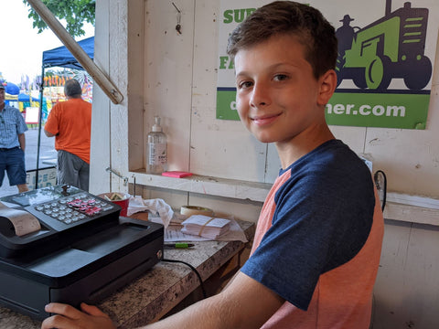 young boy at cash register