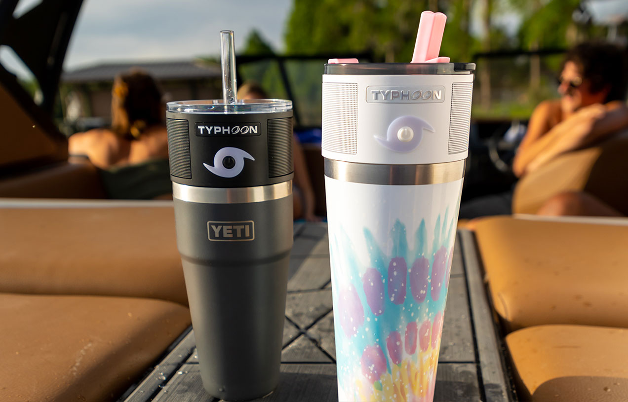 two tumblers with a black and white typhoon speaker on each