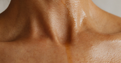 Application of skincare oil on the neck for rejuvenation and hydration of the skin