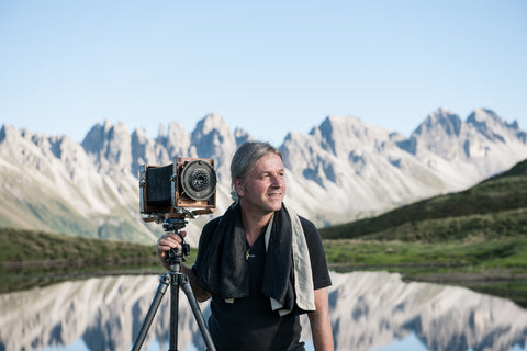 Thomas Defner in front of a mountain lake
