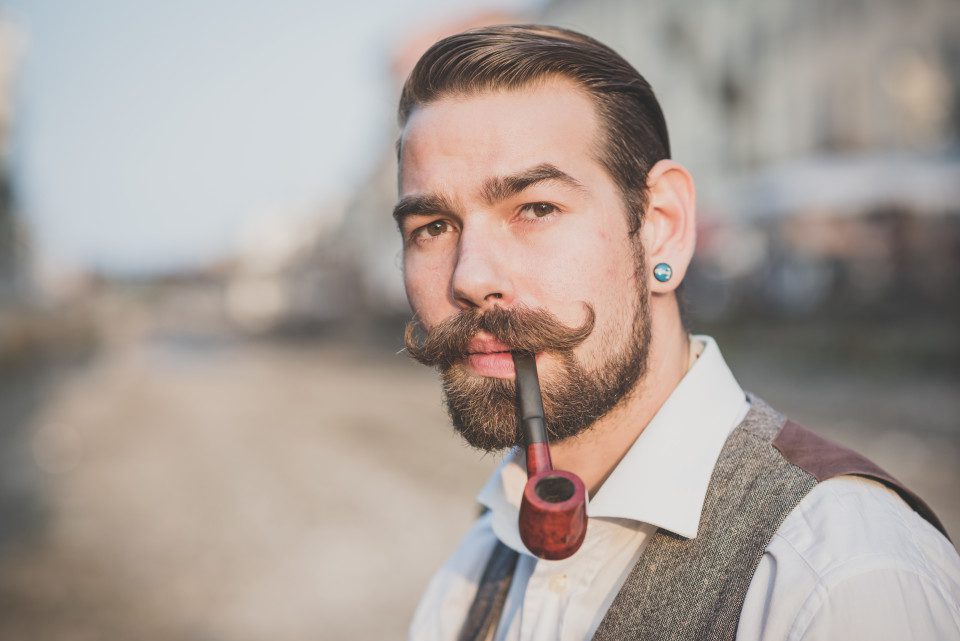 man with handlebar moustache and pipe