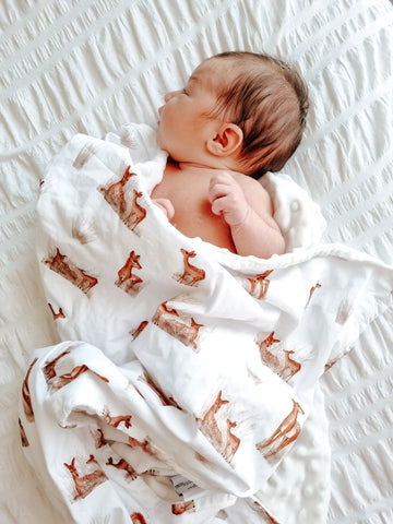 Newborn baby wrapped in a Snuggly Jacks Minky Snuggle Blanket