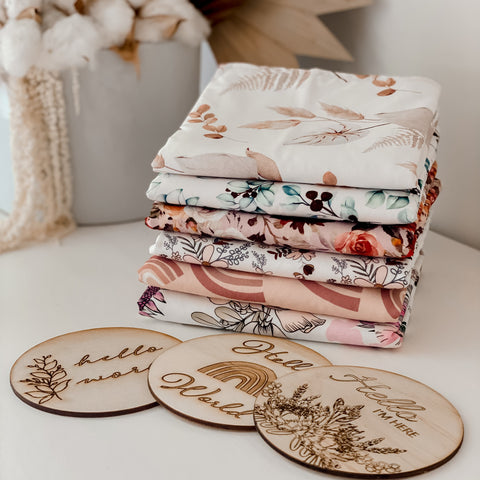 Snuggly Jacks Announcement disks and burp cloths presented in a modern nursery