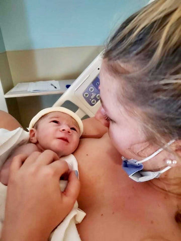 New Mother holding he newborn baby right after birth