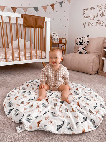 Baby Boys nursery with a round Snuggly Jacks Playmat on the floor and a 18 month old baby playing.