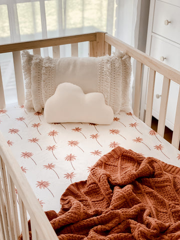 Wooden Cot with a Snuggly Jacks Summer Storm Fitted Cot Sheet and Cinnamon Knitted Blanket