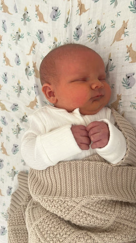 Newborn Baby Boy wrapped in a Snuggly Jacks Taupe Knitted Blanket