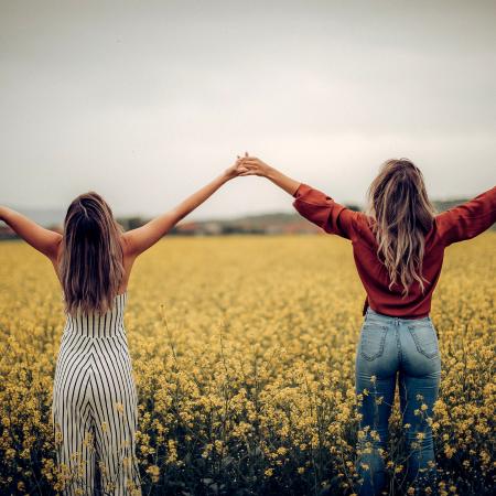 Birthday wishes for sister. Sisters holding hands.