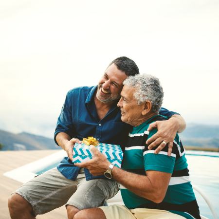 Father giving gift to son.