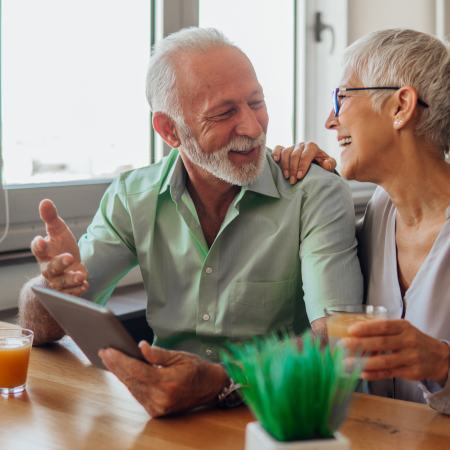 Parents with tablet at the kitchen table