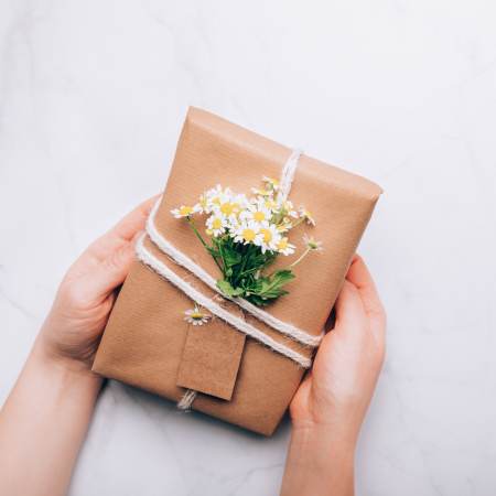 Gift wrapped in brown paper with flowers