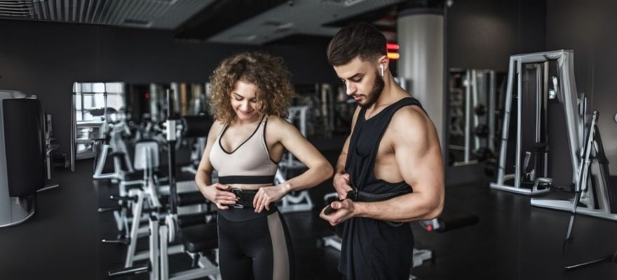 Man and Woman Wearing Properly Sized Lifting Belt | Hustlers Only UK