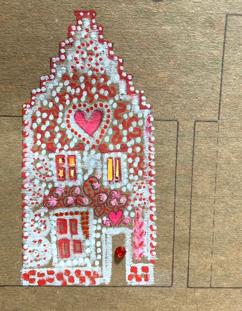 illustrated gingerbread house with white paint and embellishments