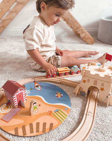 Toddler playing with Coastal Clean Up Train Set