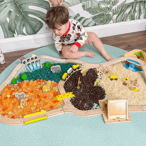 Boy enjoying a sensory activity with Safari Train Set