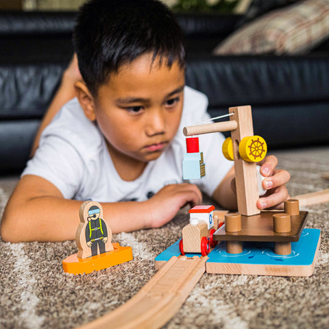 Boy playing with Bigjigs Rail Crane Dock