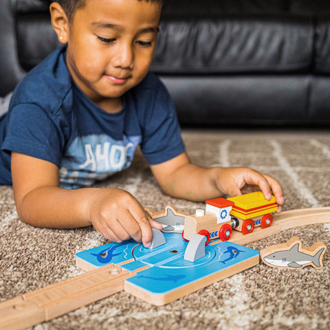 Boy playing with Shark Attack Train Accessory