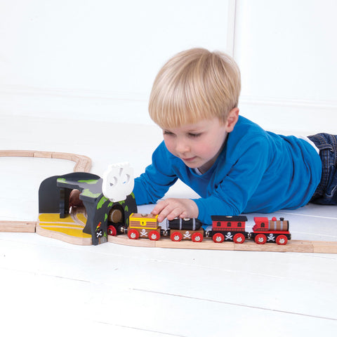 Child playing with Skull Cave wooden train toy