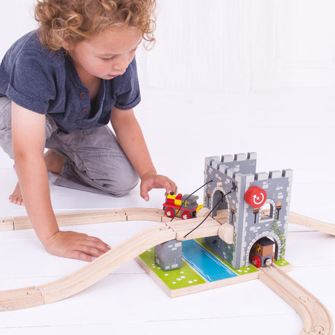 Boy playing with Castle Drawbridge wooden train accessories