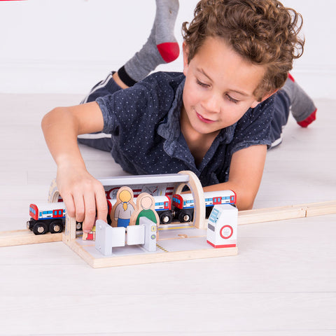 Boy playing with Underground Station and toy train