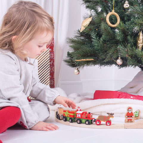 Girl playing with Bigjigs Rail Christmas Train