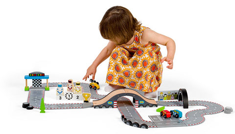 Girl playing with Roadway Race Day car track toy