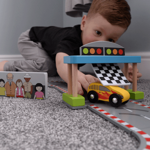 Child playing with Roadway Race Day toy car race track