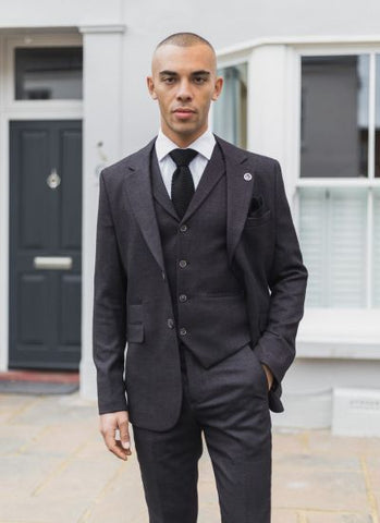 Great combination three piece suit with contrasting dress shoes and bold  tie.