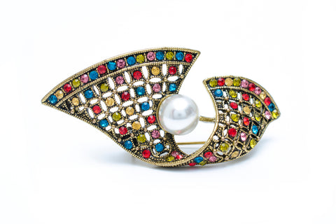 An Art Deco piece of jewellery, a brooch featuring the distinctive set of geometric shapes, colourful gems and a statement pearl