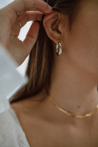 A timeless collection of elegant hoops, simple silver rings and a gold necklace