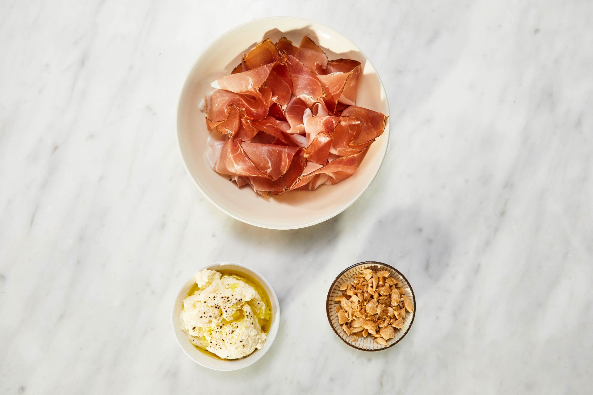 Pizza Crostini with Ricotta, Speck and Marcona Almonds