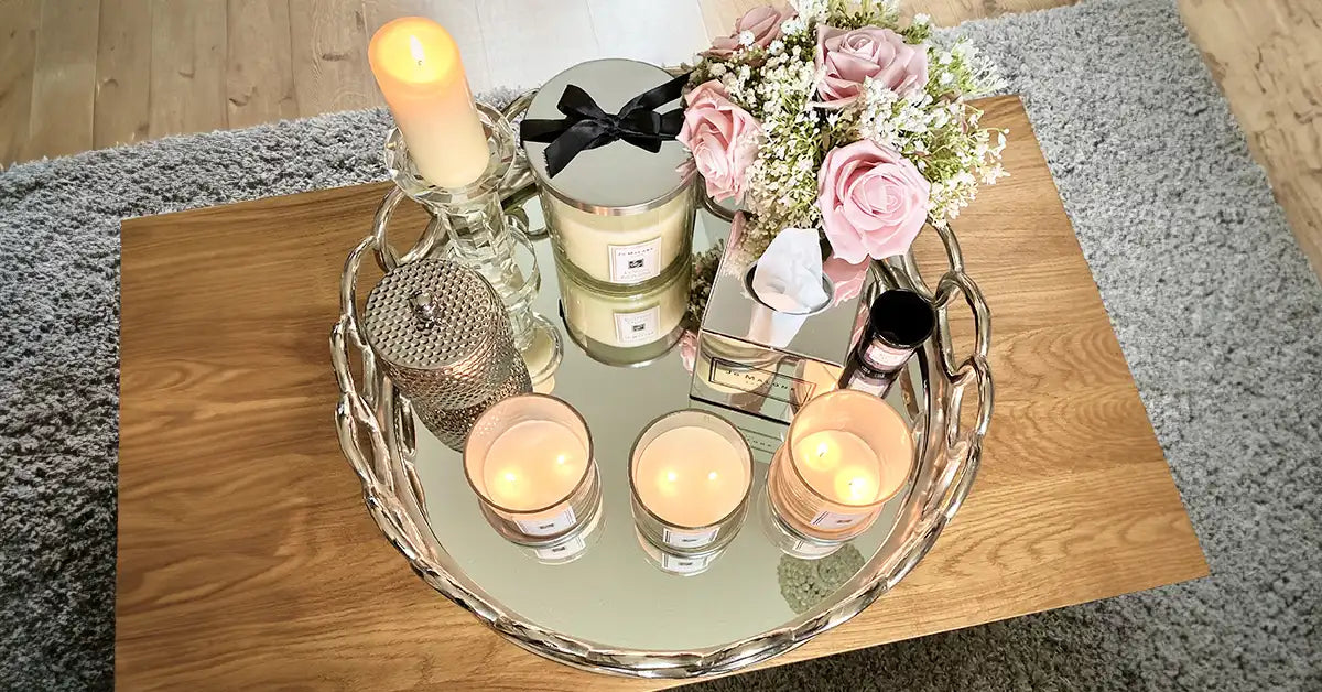 scented candles on mirror tray