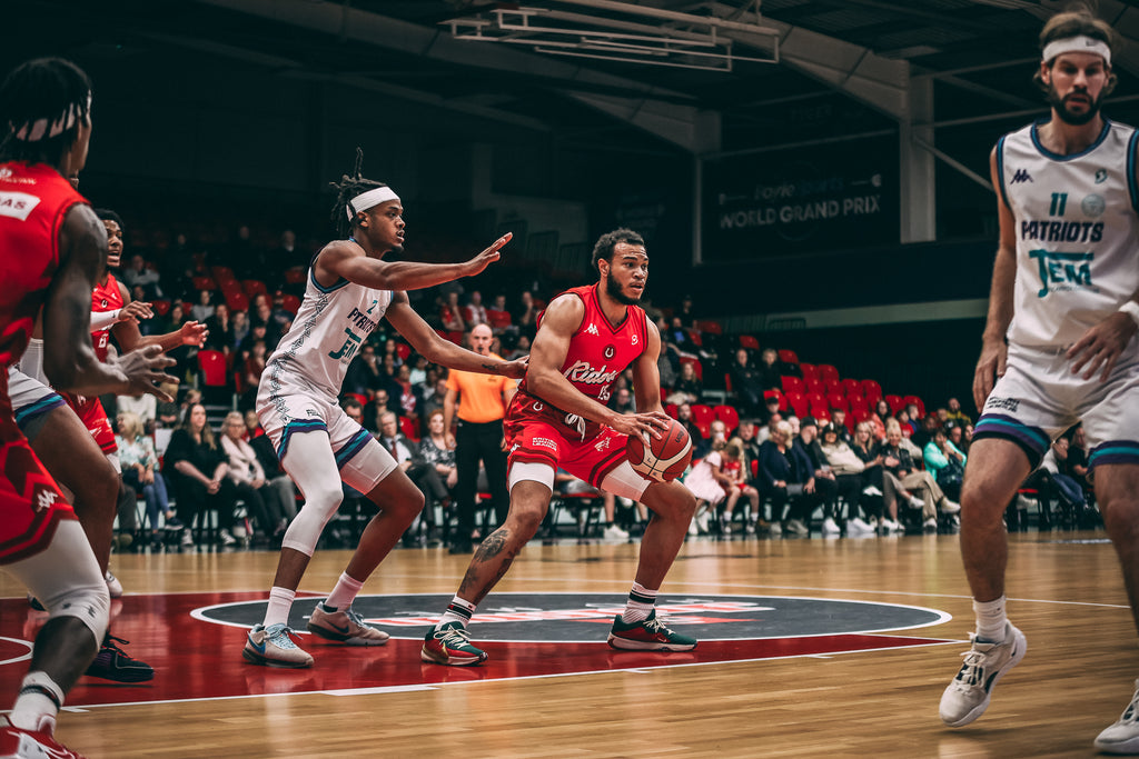Leicester Riders player playing the ball against the Plymouth City Patriots wearing Kappa kit
