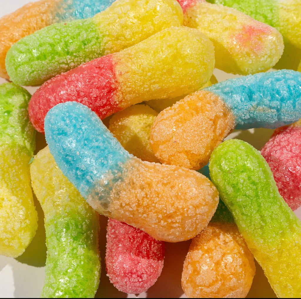 Freeze-dried sour worms in various colors and shapes.