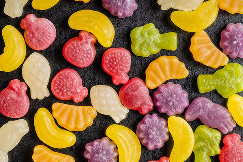 Multi-colored fruit-shaped gummies.