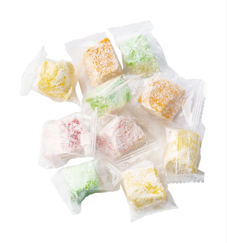 A colorful heap of traditional Turkish candies in assorted flavors arranged in neat cubes.