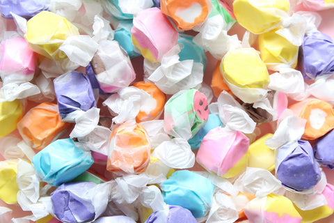 Assorted colorful taffy in wrappers.