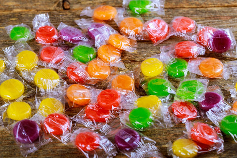 Top down image shot of candy colorful candies on wooden background.
