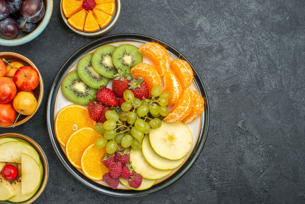 Various fruits arranged in bowls with a black background.