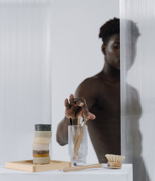 Argan Oil for Beard Care - man grabbing a toosh brush in the shower