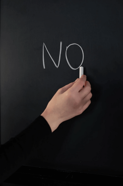 the word no on a chalkboard 