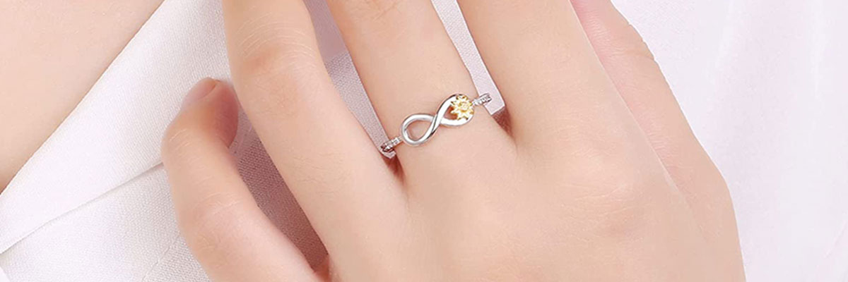 What types of metals and gemstones are suitable for infinity rings?