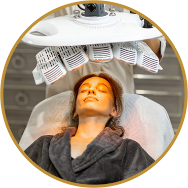 Lady laying her face under LED Therapy light