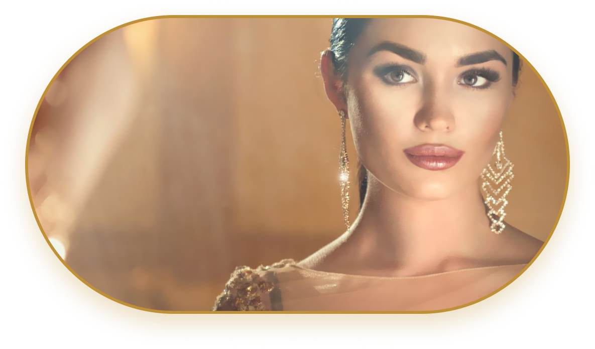 Beautiful lady dressed in gold with gold dangling earrings