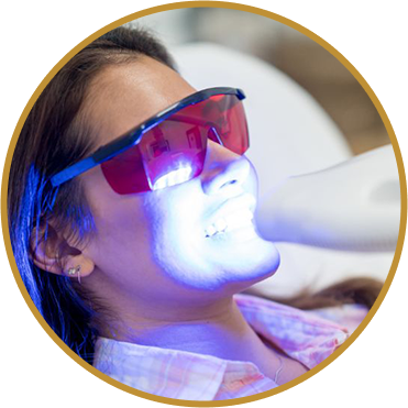 Lady with safety goggles having LED Teeth whitening treatment