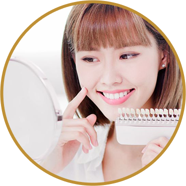 Lady smiling looking in a mirror showing her whitened teeth