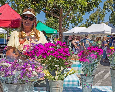 Flower vendor with flowers at Farmers Market, San Luis Obispo