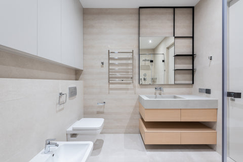 a washroom with toilet and bidet near a sink